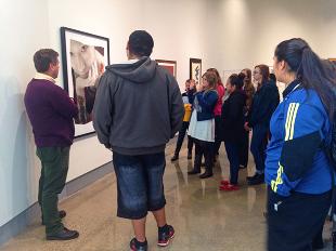 Charles Mason discussing an artwork on display in the Kruizenga Art Museum with students from a Hope College class.