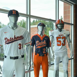 mannequins display the currnt baseball, softball and football uniforms.