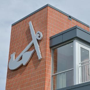 The large anchor attached to exterior of the Jim Herringa Athletic Center.