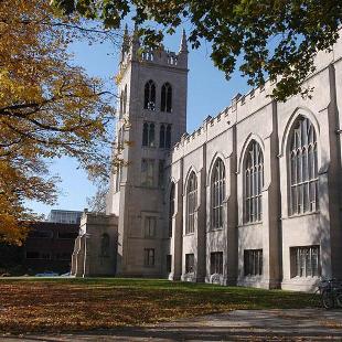 Students recline outside of Dimnent Memorial Chapel on a fall day.