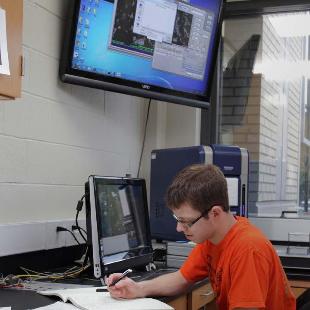 A student studies in VanderWerf Hall